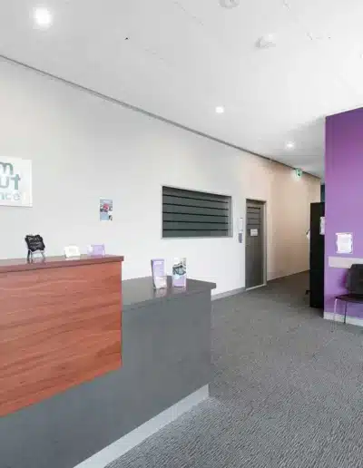 Dance Studio Reception Area With Purple Wall And Modern Desk Dance Studio Reception Area With Purple Wall And Modern Desk