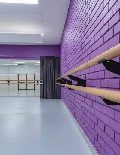 Modern Dance Studio With Purple Walls And Ballet Barres Modern Dance Studio With Purple Walls And Ballet Barres